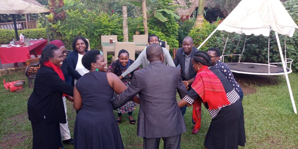 participants holding hands in a circle or a team building exercise