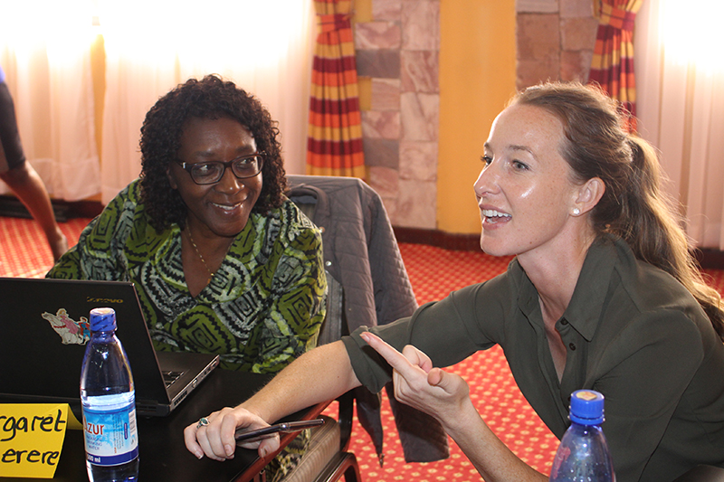 A professor and post-doc fellow chat at a training session