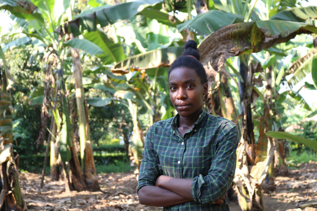 Woman standing in field of trees