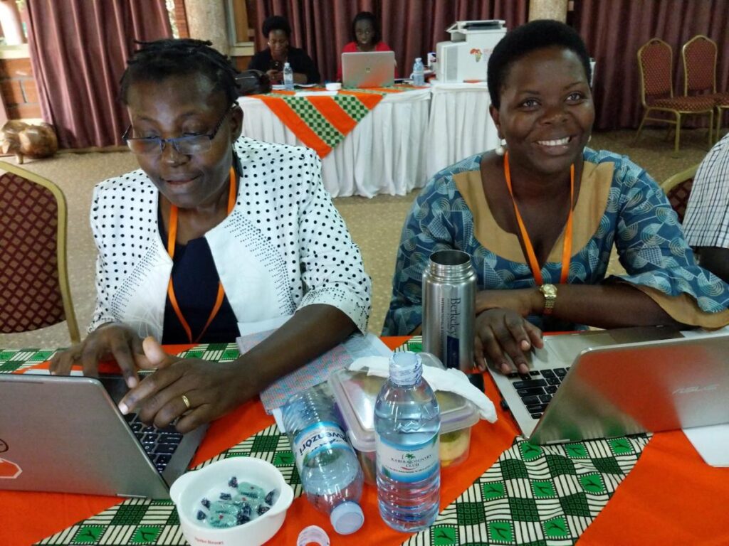 twp trainers sit at a table prepare at a training session