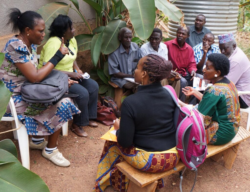 members of GREAT talk with farmers